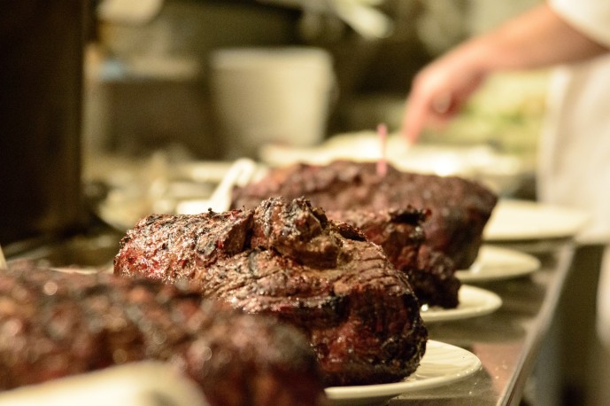 The steaks have been plated. Waiting to be handed off to the servers.