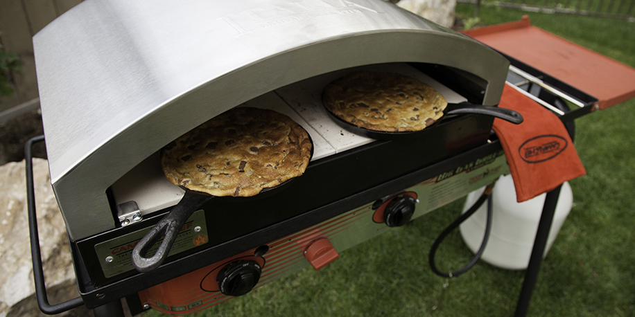 Cookies in mini skillets baking in outdoor pizza oven