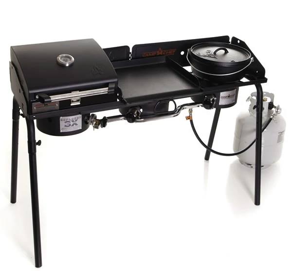 Load image into Gallery viewer, The Camp Chef Explorer is a portable outdoor stove with three sections: a grill with lid and temperature gauge, a central flat griddle, and a right-side pot burner, all fueled by propane for versatile outdoor cooking.