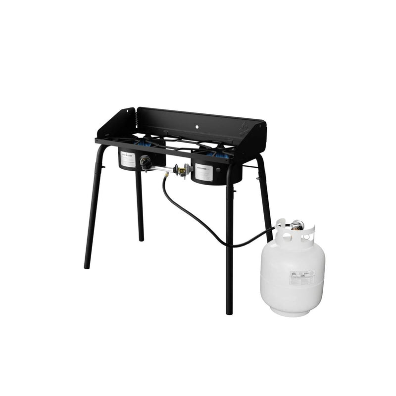 Load image into Gallery viewer, The Camp Chef Explorer is a black, two-burner cooking system on four legs, shown with a white propane tank attached—ideal for outdoor cooking and camping.