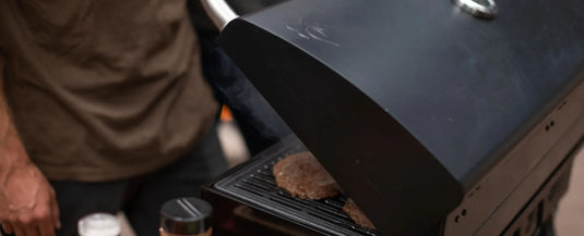 person grilling with grill box