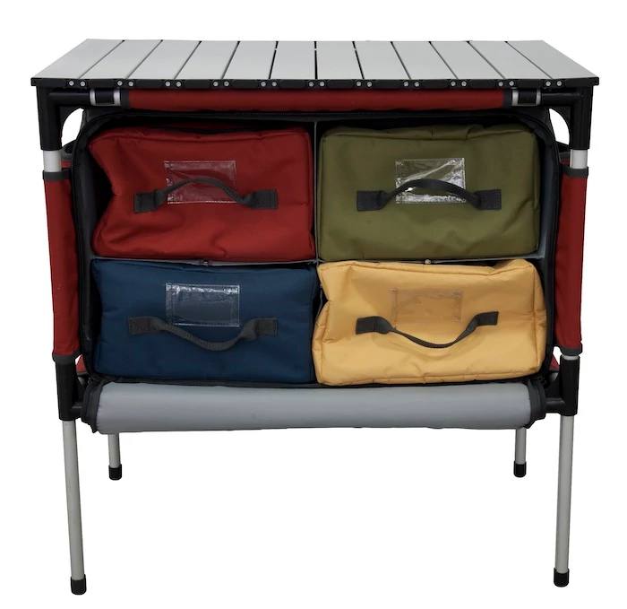 Load image into Gallery viewer, The Camp Chef Sherpa Table &amp; Organizer is a versatile camp organizer with a sturdy metal frame, flat tabletop, and four colorful drawers—red, green, blue, yellow—each with handles and clear label slots for convenient outdoor storage.
