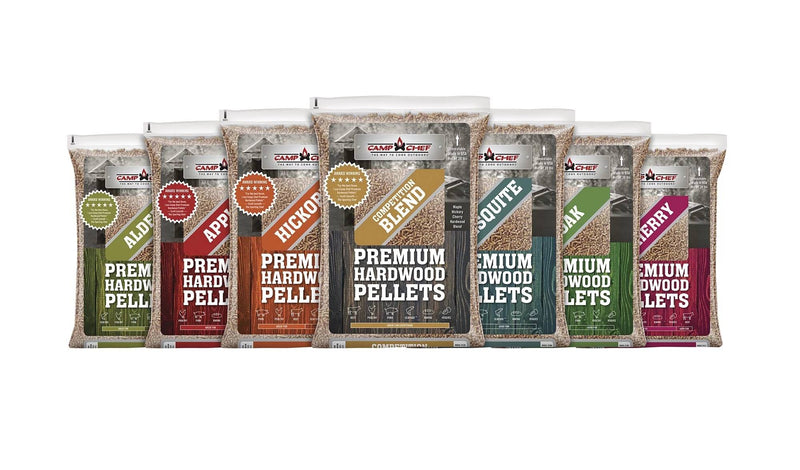 Load image into Gallery viewer, Eight bags of Camp Chef Hardwood Pellets—Alder, Apple, Hickory, Oak, Cherry, Competition Blend, and Mesquite—are lined up side by side for a rich smoke flavor in your grilling.
