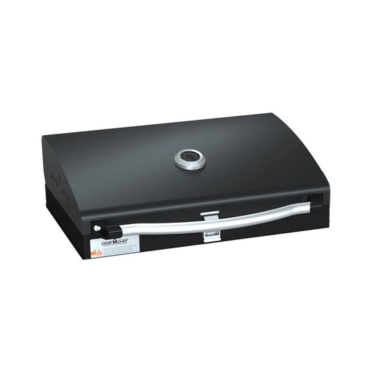 The Camp Chef BBQ Grill Boxes 16 is a black tabletop grill featuring cast iron grates, a curved silver handle, a built-in temperature gauge on the lid, and a front latch, shown against a white background.