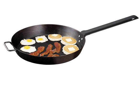 The Camp Chef Lumberjack Skillet - 20” features a non-stick surface, ideal for cooking three strips of bacon, three sunny-side-up eggs, and three pancakes with butter.