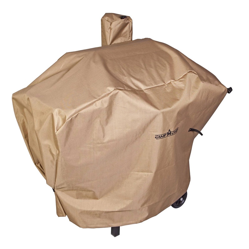 Load image into Gallery viewer, A beige Camp Chef Pellet Grill Cover, slightly wrinkled with a small rectangular logo, shields an outdoor grill with wheels from the elements and is perfect for a Camp Chef pellet grill smoker.

