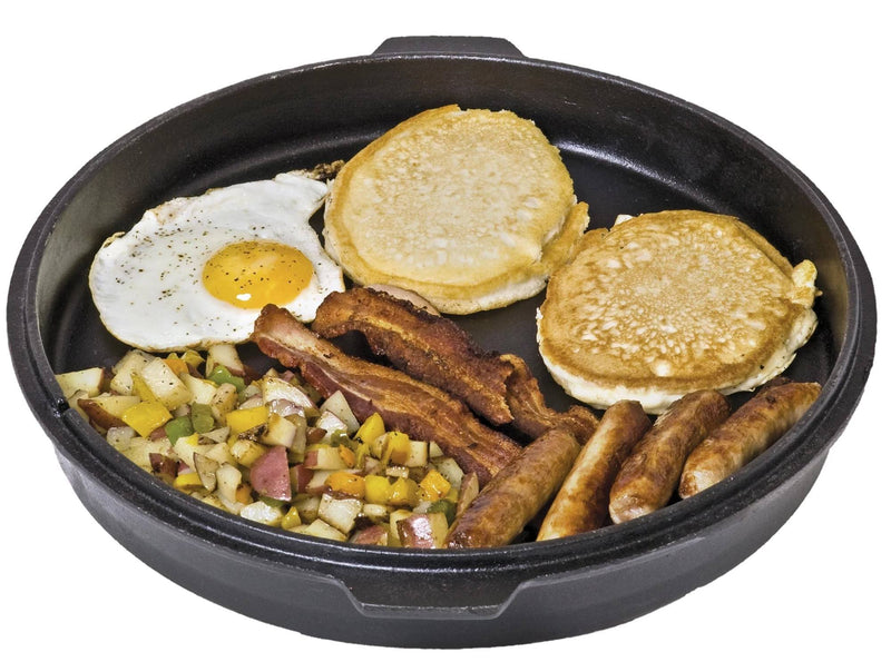 Load image into Gallery viewer, A Camp Chef Deluxe Dutch Oven filled with a breakfast meal: a sunny-side-up egg, two pancakes, crispy bacon strips, sausage links, and diced potatoes with peppers.
