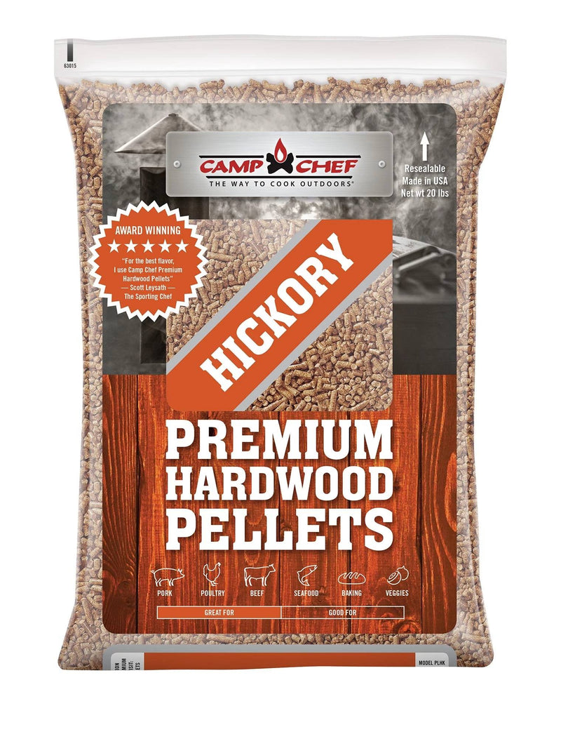 Load image into Gallery viewer, A 20-lb bag of Camp Chef Hardwood Pellets in hickory flavor delivers rich smoke for grilling, baking, roasting, and veggies. The mostly clear packaging features orange and white text plus wooden plank graphics.
