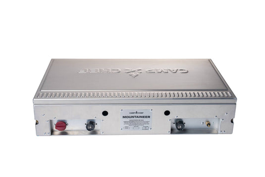 The Camp Chef Mountaineer outdoor cooking system features front control knobs and ports, all set against a white background.