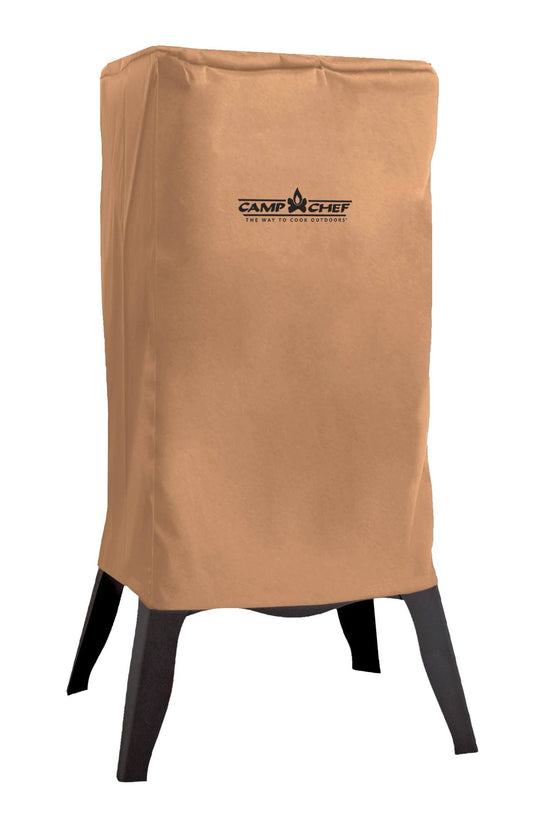 A tan, weather-resistant SmokeVault Cover by Camp Chef protects a tall, rectangular outdoor appliance with four black legs.