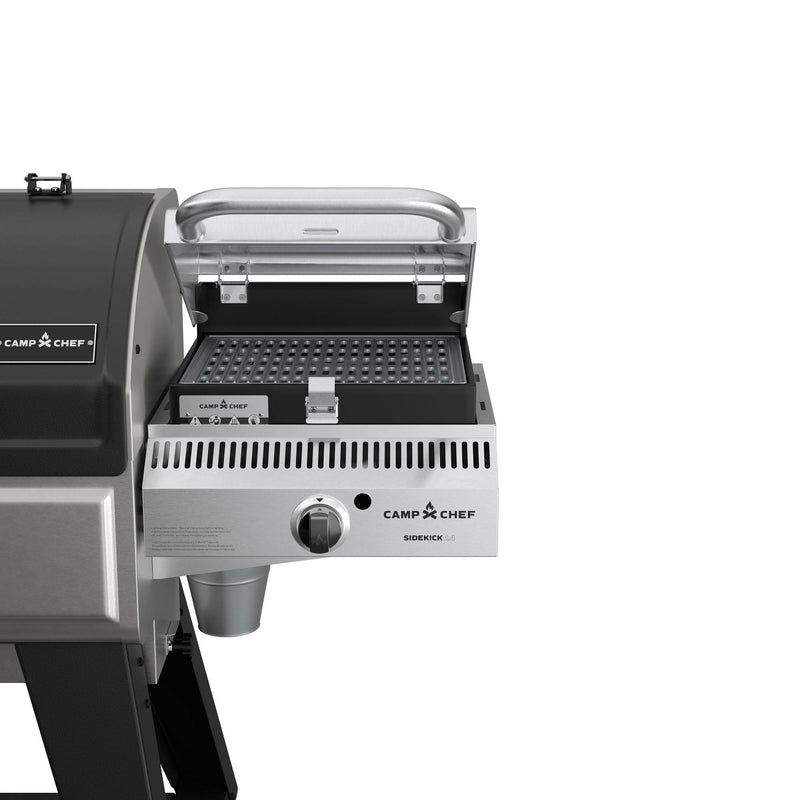 Load image into Gallery viewer, A close-up of the Camp Chef Woodwind Pro 24 grill with a silver sidekick attachment, flat top surface, control knob, and integrated Smoke Box for wood pellets, set against a plain white background.
