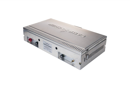 The Camp Chef Mountaineer is a rectangular metallic gas oven with control knobs, vents, and a side label—perfect for outdoor cooking—shown on a white background.