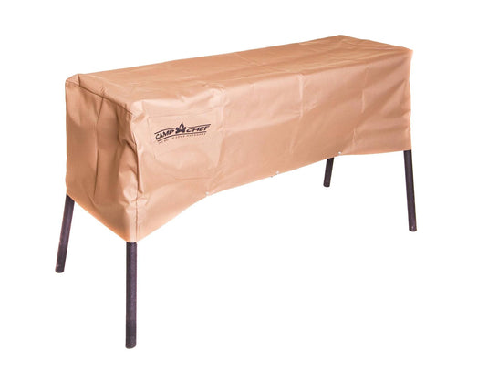 A rectangular Camp Chef 14 IN Stove Cover in tan, weather-resistant material protects an outdoor grill with four black metal legs, all set against a white background.