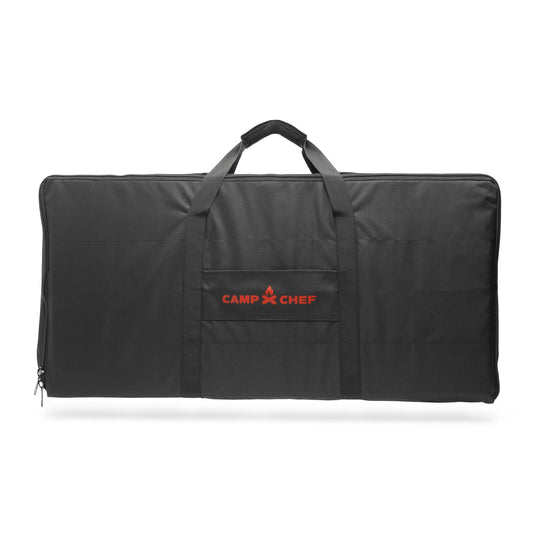 The Camp Chef Carry Bag 14 is a large black bag with handles and a front pocket, designed for 2-burner systems, featuring the red Camp Chef logo in the center.