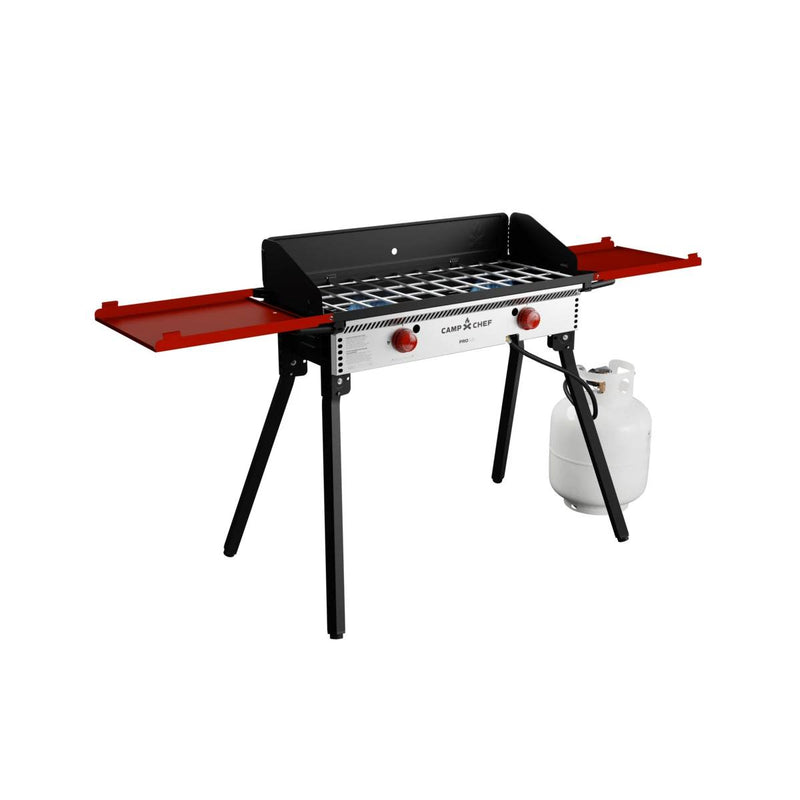 Load image into Gallery viewer, The Camp Chef PRO 14 is a portable propane grill featuring a silver and black body, two red knobs, red side shelves, four black legs, and a right-side propane tank—ideal for outdoor cooking with the trusted Camp Chef system.
