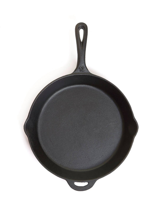 The Camp Chef Cast Iron Skillets feature a handle, dual pouring spouts, and an embossed number 12 near the handle—perfect for kitchen or outdoor cooking. Shown from above on a white background.