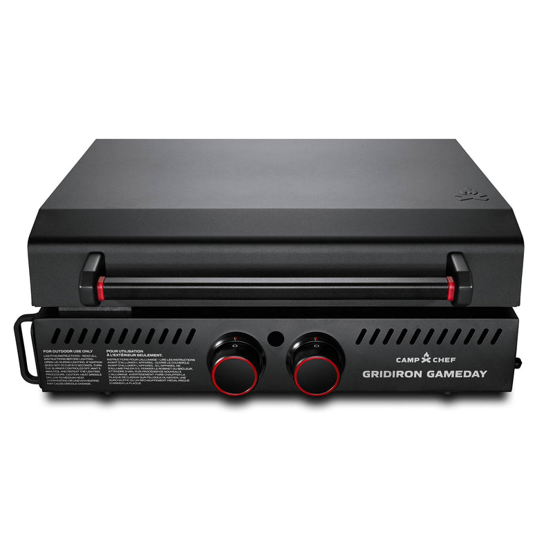 Load image into Gallery viewer, The Camp Chef Gridiron Gameday grill features a black finish, closed lid, dual control knobs, and front ventilation slits—ideal for outdoor cooking and portable tailgates.
