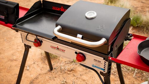 Camp Chef Pro Series grill on a camping site with desert landscape in the background