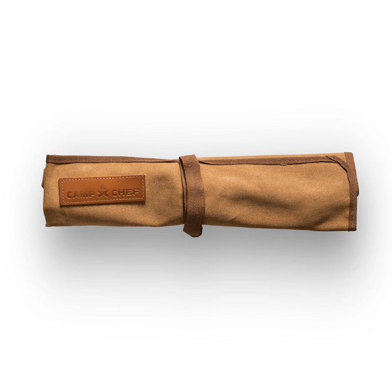 Load image into Gallery viewer, The Camp Chef 4 Piece Carving Set features a tan canvas knife roll with a leather Camp Chef patch and strap, ideal for storing stainless steel knives. Displayed on a white background.
