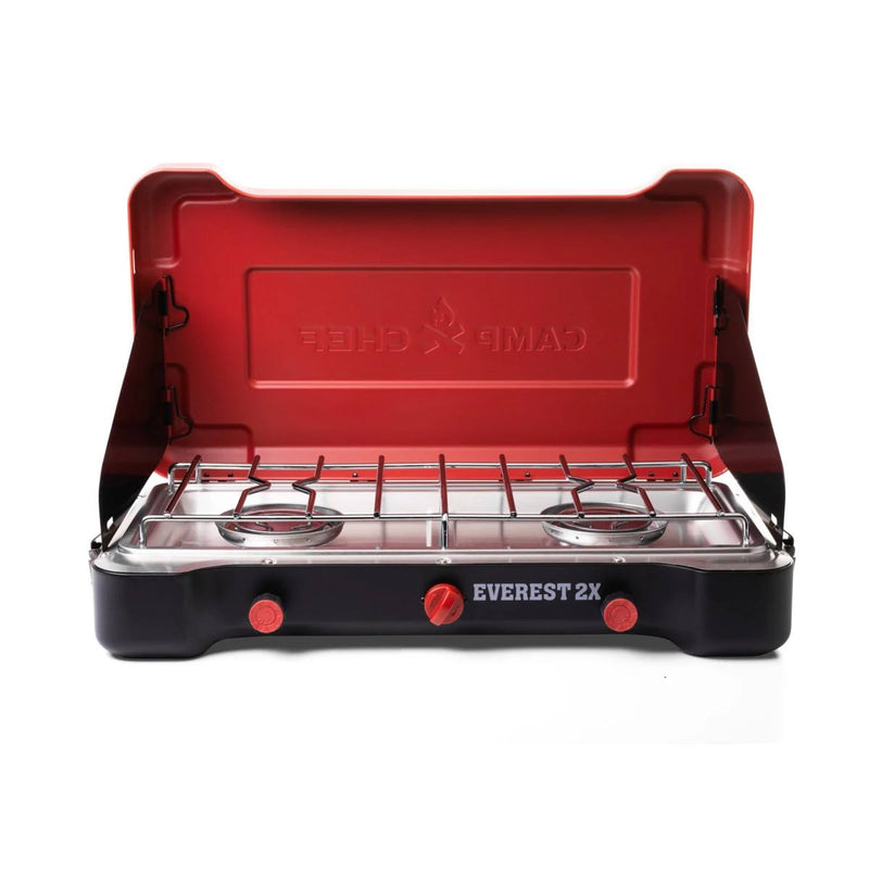 Load image into Gallery viewer, The Camp Chef Everest 2X is a portable stove with two burners, dual control knobs, metal grates, and a red lid embossed with the brand—ideal for outdoor cooking on camping trips.

