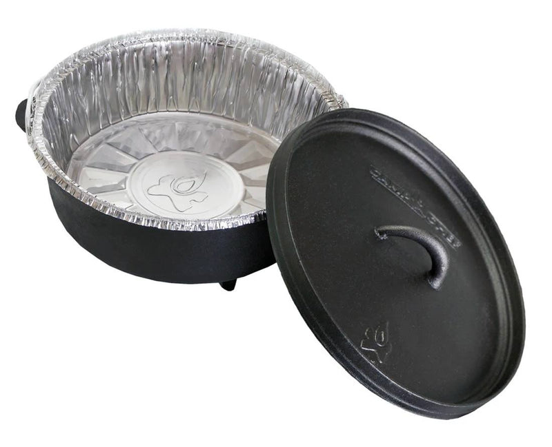 Load image into Gallery viewer, A black cast iron Dutch oven is shown with a Camp Chef Disposable Dutch Oven Liner inside and the lid nearby, making cleanup easy after deep Dutch oven cooking.
