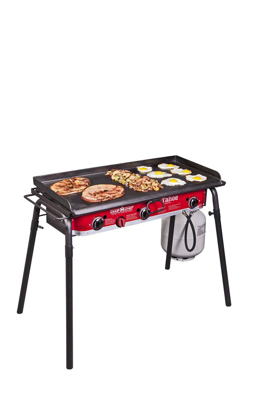 The Camp Chef Griddles 16 is a red and black four-burner flat top griddle, perfect for cooking pancakes, eggs, and hash browns. It features an attached propane tank and is shown against a white background.