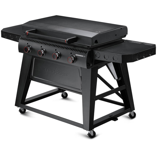 The Camp Chef Gridiron 36 is a black outdoor gas grill featuring four control knobs, a flat griddle surface for even heating, side shelves, wheels for mobility, and a closed lid—all in a sturdy, modern design for easy clean-up.