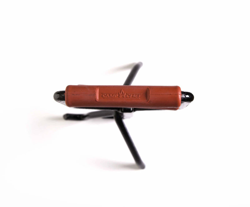 Load image into Gallery viewer, The Camp Chef Dutch Oven Lid Lifter, featuring a black metal body with a brown branded handle and two prongs, is displayed against a white background with the handle facing forward.
