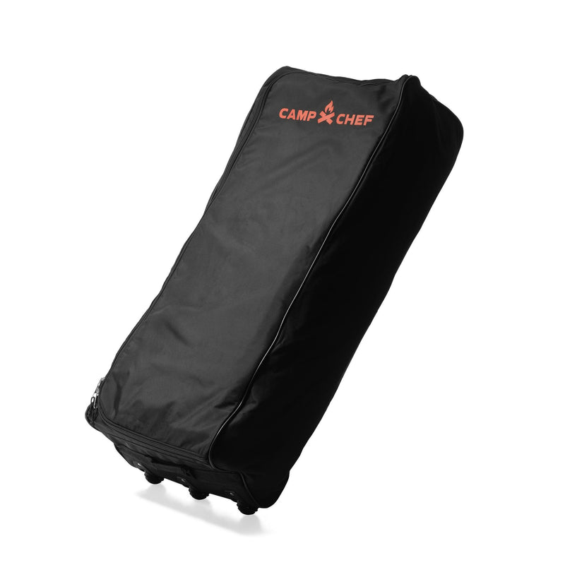 Load image into Gallery viewer, The Camp Chef Stove System Roller Bag is a black, heavy-duty carry bag with wheels and a red Camp Chef logo on top. It stands upright, features durable padded fabric, and is perfect for carrying your Camp Chef 2-burner stove.

