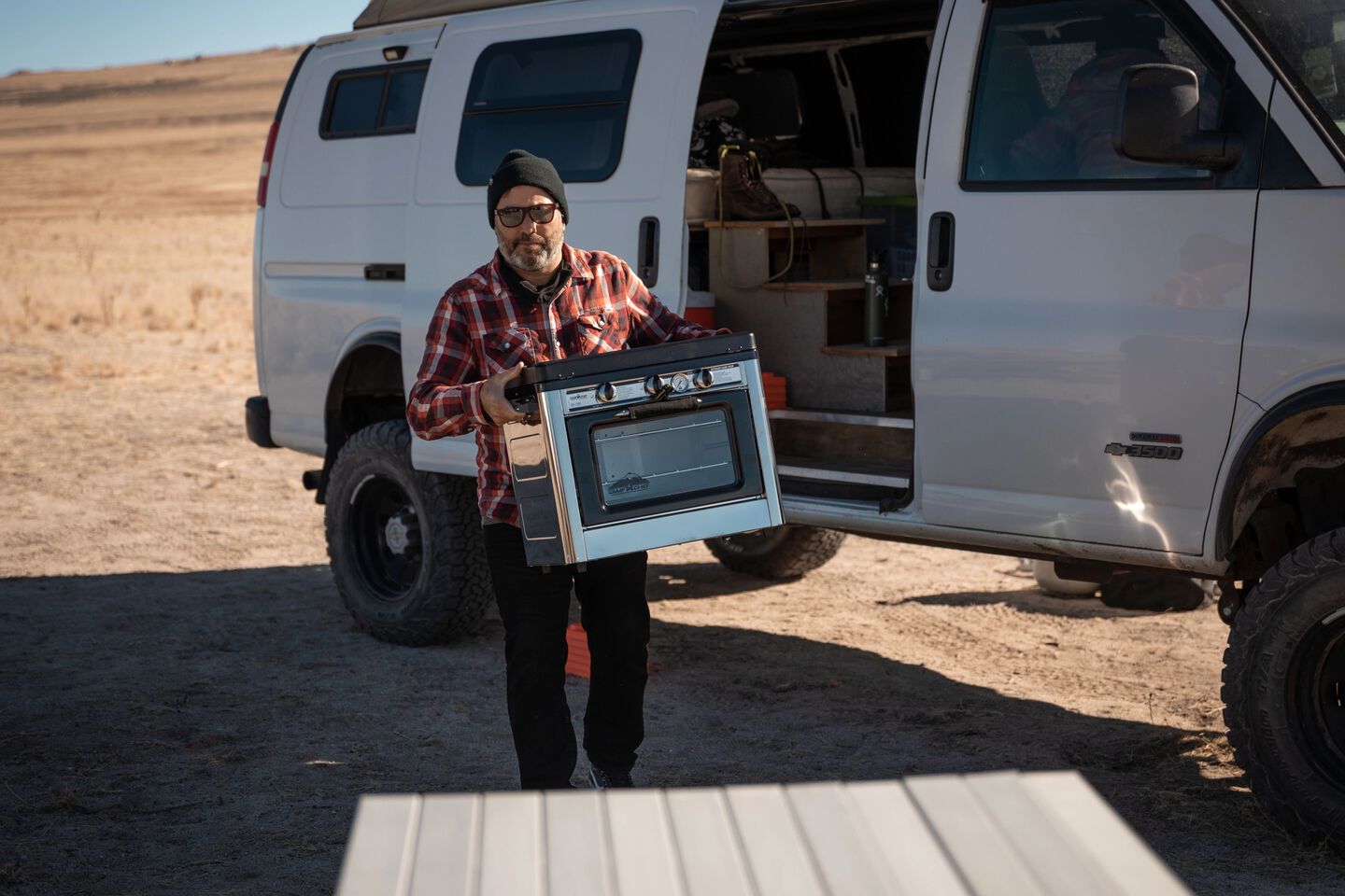 man carrying Camp Oven man carrying Camp Oven