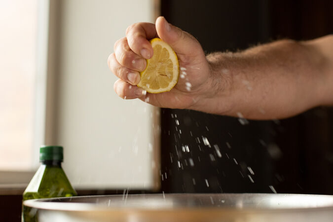 squeezing a lemon for the gluten free pizza recipe
