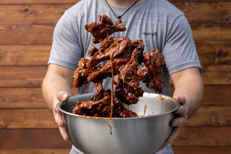 mixing chicken in sauce