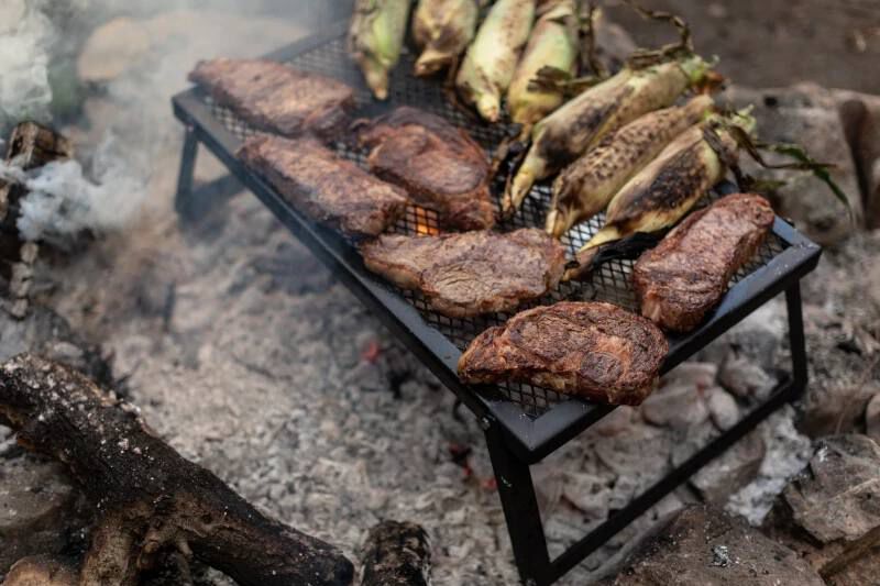 Camp chef lumberjack over fire grill shop